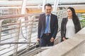 City life of asian businessman. Confident business people walking to work at office and talking together Royalty Free Stock Photo