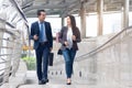 City life of asian businessman. Confident business people walking to work at office and talking together Royalty Free Stock Photo