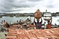 City life in Dhaka with workers, slum and river traffic