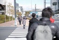 City life in Tokyo, Japan with people walking on footpath and japanese language signpost on top is bicycle, pedestrian defined