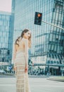 City life. Woman in modern town. Fashion street style vogue. Fashionable girl walking on streets. Royalty Free Stock Photo