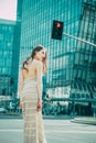 City life. Woman in modern town. Fashion street style vogue. Fashionable girl walking on streets. Royalty Free Stock Photo