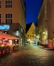 City night life  street cafe tables people dinner pink light on table Lifestyle Travel Restaurant City Light Old Town Tallinn , Royalty Free Stock Photo