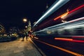 City light trails of moving red London bus at night Royalty Free Stock Photo