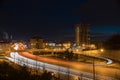 A city lights and cars riding on the road. Modern buildings in night lights.