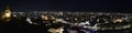 City lights of Graz and the famous clock tower Grazer Uhrturm on Shlossberg hill, Graz, Styria region, Austria, by night. Royalty Free Stock Photo