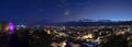 City lights of Graz and the famous clock tower Grazer Uhrturm on Shlossberg hill, Graz, Styria region, Austria, after sunset. Royalty Free Stock Photo