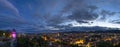 City lights of Graz and the famous clock tower Grazer Uhrturm on Shlossberg hill, Graz, Styria region, Austria, after sunset. Royalty Free Stock Photo