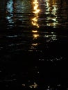 City lights reflect in the waters of the river at night. Background Royalty Free Stock Photo