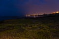 The city lights of Torrevieja. In the foreground the rocky coast at night. Royalty Free Stock Photo