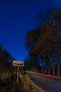 City limits sign at night