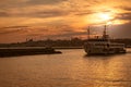 City lines cruise ship sails at the beautiful moment of sunset, summer landscape of istanbul city behind. Royalty Free Stock Photo