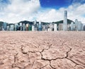 A city looks over a cracked earth landscape