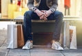 City, man sitting and sale with shopping bags on floor, sidewalk or street with sneakers, relax or waiting for taxi. Guy Royalty Free Stock Photo