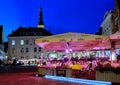 City night life  street cafe tables people dinner pink light on table Lifestyle Travel Restaurant City Light Old Town Tallinn , Royalty Free Stock Photo