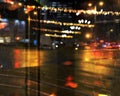 Rainy city night light  street reflection  car traffic buildings blurred light red yellow bokeh vew from window urban  holiday  li Royalty Free Stock Photo