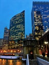 City night lights reflect over freezing Chicago River and el train passing over Lake Street in winter. Royalty Free Stock Photo