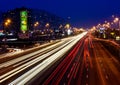 City by night:main roads with cars and reflections.