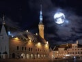 City at Night moon on starry sky  medieval Tallinn old town town hall square at night light reflection  starry night  travel to E Royalty Free Stock Photo