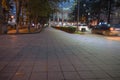 City night park in autumn with paths strewn. Park in the evening time, Cars on the street Royalty Free Stock Photo