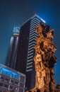 City night scene. Night view of high-rise buildings. Contrast between office building and sculpture. Urban scenery