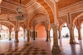 City Palace Jaipur ancient hallway with ancient wall art with columns at Rajasthan India