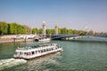 City of Paris with tourist boat close the bridge on Seine river during spring time in Paris, France