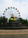 City park with apple sculpture and ferriswheel