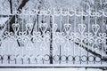 City park fence in the snow, winter landscape in the city Royalty Free Stock Photo