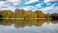 City park in Munich, Germany. Grass field, trees and reflections in a pond Royalty Free Stock Photo