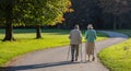 City park, Munich, Germany. View of a mature couple walking on a path