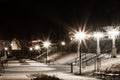 City park in the night scenery with a place to rest. Landscape of night city park in the spring. Benches, paths and lights. Royalty Free Stock Photo