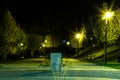 City park in the night scenery with a place to rest. Landscape of night city park in the spring. Benches, paths and lights. Royalty Free Stock Photo