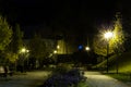 City park in the night scenery with a place to rest. Landscape of night city park in the spring. Benches, paths and lights. Royalty Free Stock Photo