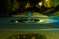 City park in the night scenery with a place to rest. Landscape of night city park in the spring. Benches, paths and lights. Royalty Free Stock Photo