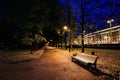 City park at twilight with bench, pathway, alley and trees autumn. Autumn night park.