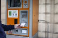 City parking meter for payment. A man`s hand takes a ticket. Moscow, Russia, 15/05/2020 Royalty Free Stock Photo