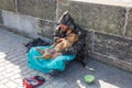 City Prague, Czech Republic. On the street the beggar with dog treats people for money. 2019. 24. April