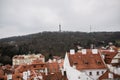 City of Prague with red roofs and Church in fog. City view of Praha old city. Rustic grey colors toning Royalty Free Stock Photo