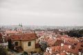 City of Prague with red roofs and Church in fog. City view of Praha old city. Rustic grey colors toning Royalty Free Stock Photo