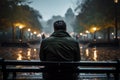 City rain contemplation person on a bench absorbs the wet ambiance