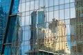 City reflected in windows of modern office glass building wall
