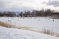 City Riga, Latvia. Frozen river and anglers fishing fish