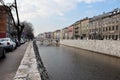 City river scenery image with view of old stone bridge and historic buildings Royalty Free Stock Photo