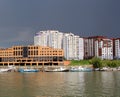 City on the river boats of a multistory building modern city river navigation of river ships, the shipyard Marina pier waterfront