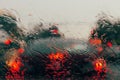 City road seen through rain drops on the car windshield Royalty Free Stock Photo