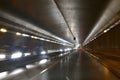 Road traffic in rainy night tunnel with cars and lights blur effect Royalty Free Stock Photo