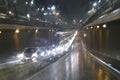 Road traffic in rainy night tunnel with cars and lights blur effect Royalty Free Stock Photo