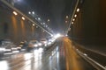 Road traffic in rainy night tunnel with cars and lights blur effect Royalty Free Stock Photo