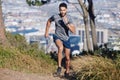 City, runner and man running in nature training, cardio exercise and endurance workout for a marathon. Sports, fitness